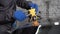 Close-up shot of the hand of a master mechanic at a car service station, leveling the dent on the hood of the car.