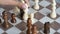 Close-up shot hand of woman playing the chess board metaphor business competition for win and lose select focus shallow depth of f