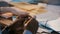 Close-up shot, hands of African American office worker holding pencil, stressed at team meeting discussion behind table.