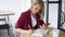 Close up shot of hands of Beautiful and young successful business woman with notepad in a cafe, working as a freelancer