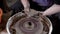 Close up shot of a hands of a female pottery crafting new vase in the workshop.