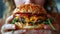 Close up shot of hands holding a mouth watering and irresistible burger, ready to take a bite