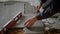 Close up shot of the hands of a man who checks the level of the surface on the ceramic tile during the laying of the