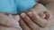 Close-up shot hands of the mother using scissor to cut the nail of a daughter, for health care concept