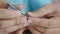 Close-up shot hands of the mother using scissor to cut the nail of a daughter, for health care concept