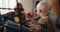 Close-up shot of a happy albino boy with white hair and a short haircut playing electronic drums using special sticks