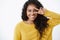 Close-up shot happy sincere african-american female student enjoying halloween party, standing in yellow sweater showing