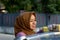 Close up shot hijab woman washing car roof with a smile