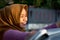 Close up shot hijab woman washing car roof with a smile