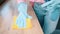 Close up shot of Housewife in blue rubber gloves washes, spraying windowsill at room