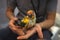 Close up shot of human hand holding beautiful green parrot chicks