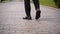 Close up shot of hurry businessman in black formal suit feet in loafer's shoes walking down marble stairs of luxury