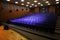 Close up shot of interior of cinema auditorium with lines of blue chairs. Horizontal shot