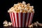 Close-up shot of large popcorn cup overflowing with classic movie theater popcorn