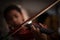 Close-up shot little girl playing violin orchestra instrumental with vintage tone and lighting effect dark and grain processed