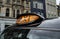 A close up shot of a London Black cab orange Taxi signal sign