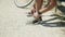 Close-up shot of man with bionic leg tying laces on sneakers