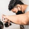 Close up shot of man getting trendy haircut. Male hairstylist serving client, making haircut using machine and comb. the concept
