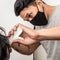 Close up shot of man getting trendy haircut. Male hairstylist serving client, making haircut using machine and comb. the concept