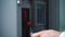 Close up shot of man hand dropping coin into vending machine, paying something.