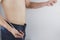 Close up shot of man with slim body measuring his waistline and torso. Healthy nutrition, diet and weight losing concept