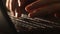 Close up shot of man typing on laptop keyboard; backlit; news, writer, media or communication