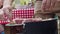 Close-up shot of mans hands flipping skewer of kebab on grill