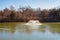 Close up shot of many Canada Geese standing by the semi frozen pond