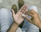 Close-up shot of a manâ€™s hands holding homeopathic pills from the bottle. Medicine and treatment concept