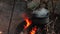 close-up shot metal cauldron on fire with smoke