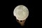 Close-up shot of the moon in the palm of a man\'s hand in the dark, perfect for wallpaper