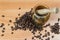 Close up shot of mortar and pestle crushing coffee beans against wooden background
