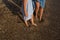 close-up shot, mother and daughter walking barefoot along the seashore