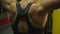 Close-up shot of muscular female athlete\'s back during active workout in the gym