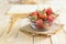 Close up shot of nature fresh strawberry in glass bowl on wooden