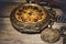 Close-up shot of an old antique vintage round mechanical pocket watch with a compass on a table