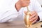 Close-up shot of an old Chinese doctor using a medicine mortar to smash Chinese herbs