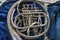 Close-up shot of an old silver French horn instrument, damaged instrument.