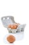 Close up shot of an open recyclable egg carton with 5 eggs inside and one egg next to it on a white background