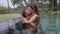 A close up shot of passionate kiss of a loving couple in the pool. The couple is spending a romantic time with each