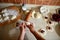 Close-up shot of pastry chef hand sculpting cherry dumplings on kitchen countertop background. Cherry dumpling lying on the wooden