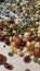 Close up shot of pile of mixed nuts, rice, and corn on a wooden table