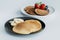 close-up shot of plates of tasty pancakes with fruits
