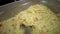 Close-up shot of a portion of boiled rice on a food distribution line in a buffet and putting breakfast on a plate.