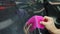 Close up shot. Process of applying a protective PPF film to a car. Hands of a professional applying a protective film of