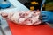 Close-up shot of a restaurant chef preparing a joint of beef