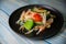 Close-up shot of a salad with enoki mushrooms, sweet peppers and broccoli