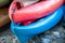 Close up shot of several Kayaks stowed by the sea shore