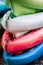 Close up shot of several Kayaks stowed by the sea shore