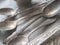 Close up shot of silver utensil cutlery spoons on tray